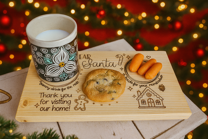 Wooden tray with cookies, carrots, and a mug on a festive background